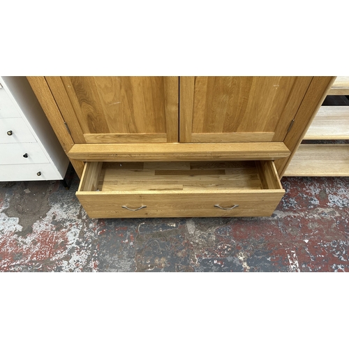 12 - A modern oak double wardrobe - approx. 194cm high x 118cm wide x 60cm deep