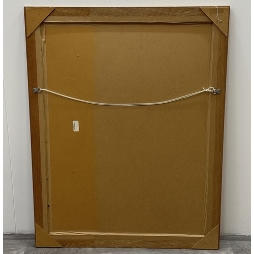 123 - A modern oak framed bevelled edge wall mirror - approx. 115cm high x 89cm wide