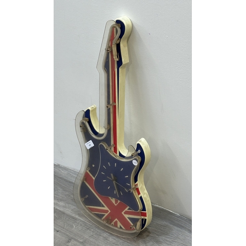 126 - A plastic Union Jack neon guitar wall clock - approx. 74cm long
