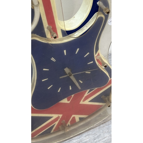 126 - A plastic Union Jack neon guitar wall clock - approx. 74cm long