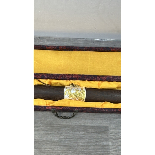 128 - A boxed Chinese decorative Tai Chi Jian engraved sword with wooden scabbard - approx. 81cm long