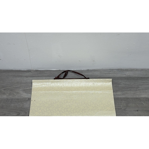 129 - A boxed Chinese calligraphy hanging scroll - approx. 163cm high x 53cm wide