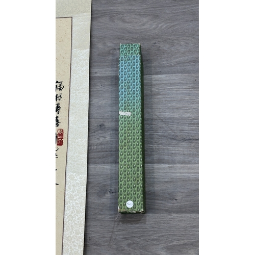 129 - A boxed Chinese calligraphy hanging scroll - approx. 163cm high x 53cm wide
