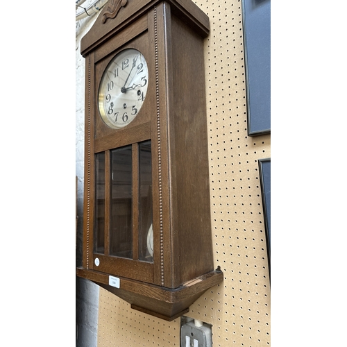 133 - An early 20th century oak cased Westminster chime wall clock with pendulum and key - approx. 80cm hi... 