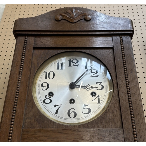133 - An early 20th century oak cased Westminster chime wall clock with pendulum and key - approx. 80cm hi... 