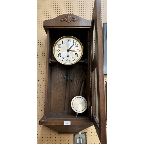 133 - An early 20th century oak cased Westminster chime wall clock with pendulum and key - approx. 80cm hi... 