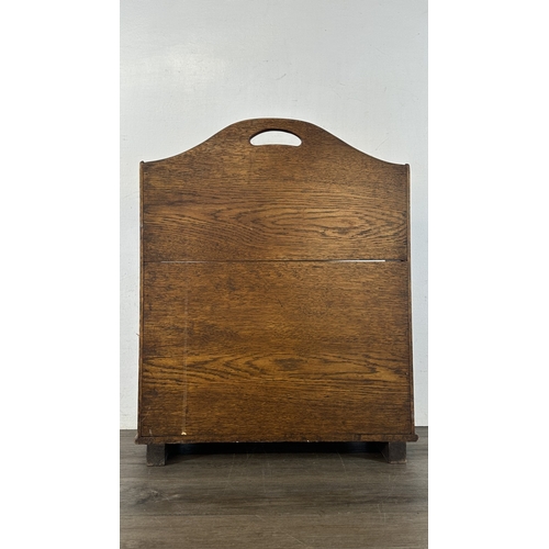 13G - An early 20th century oak two section newspaper stand - approx. 58cm high x 46cm wide x 21cm deep