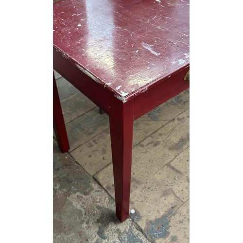 13H - A mid 20th century red painted two drawer desk - approx. 76cm high x 122cm wide x 62cm deep