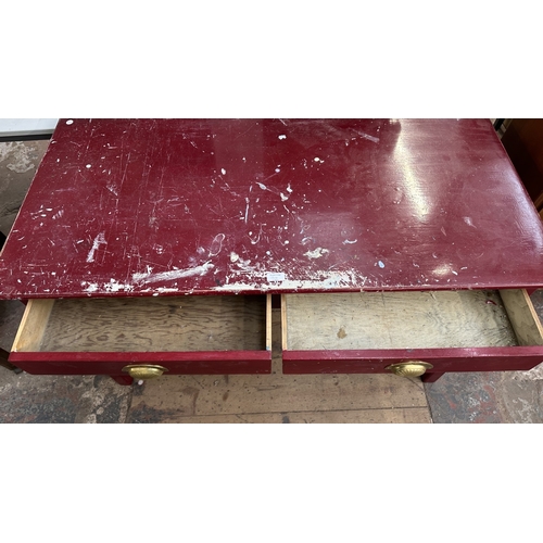 13H - A mid 20th century red painted two drawer desk - approx. 76cm high x 122cm wide x 62cm deep