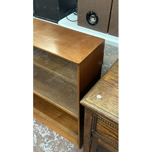 13J - A mid 20th century Herbert E. Gibbs teak bookcase with two glass sliding doors - approx. 84cm high x... 