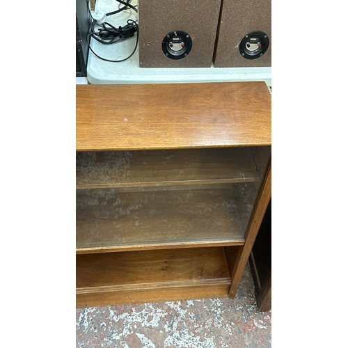 13J - A mid 20th century Herbert E. Gibbs teak bookcase with two glass sliding doors - approx. 84cm high x... 