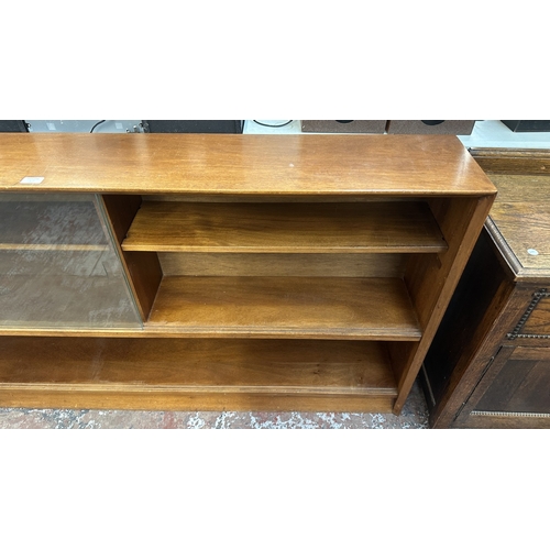13J - A mid 20th century Herbert E. Gibbs teak bookcase with two glass sliding doors - approx. 84cm high x... 