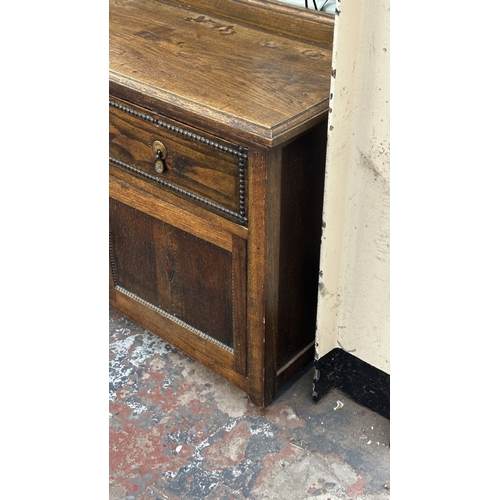 13K - An early 20th century oak sideboard - approx. 76cm high x 107cm wide x 42cm deep