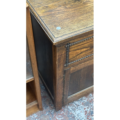 13K - An early 20th century oak sideboard - approx. 76cm high x 107cm wide x 42cm deep