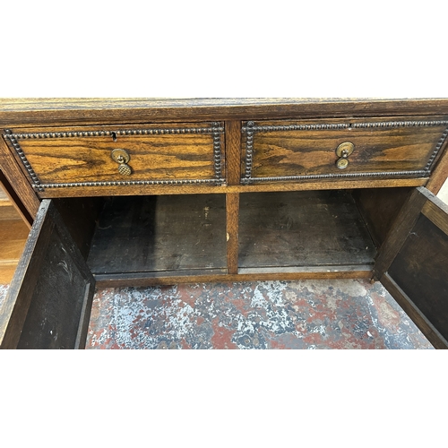 13K - An early 20th century oak sideboard - approx. 76cm high x 107cm wide x 42cm deep