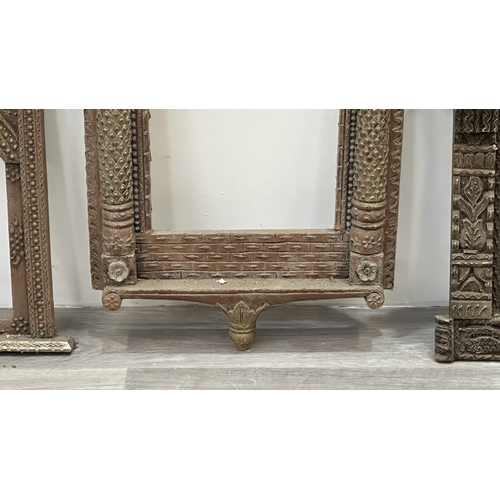 148 - Three Indian painted and carved wooden jharoka window frames - largest approx. 94cm high x 55cm wide