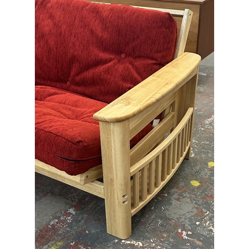 15 - A modern beech sofa bed with Kyoto Futons Ltd. red fabric upholstered cushion - approx. 82cm high x ... 