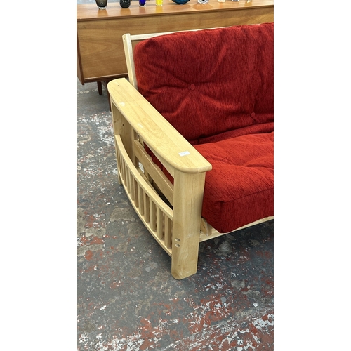 15 - A modern beech sofa bed with Kyoto Futons Ltd. red fabric upholstered cushion - approx. 82cm high x ... 