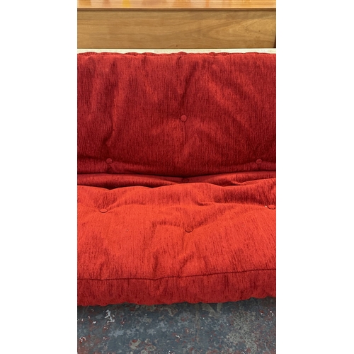 15 - A modern beech sofa bed with Kyoto Futons Ltd. red fabric upholstered cushion - approx. 82cm high x ... 