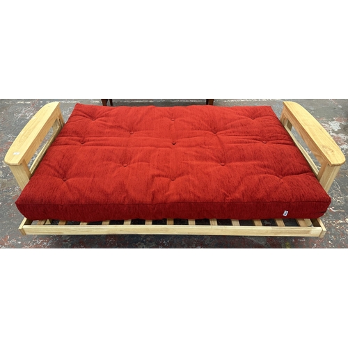 15 - A modern beech sofa bed with Kyoto Futons Ltd. red fabric upholstered cushion - approx. 82cm high x ... 