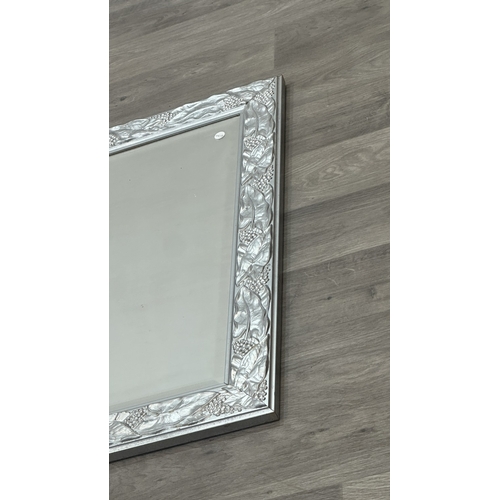 152 - A 19th century style silver painted framed bevelled edge wall mirror with grape and leaf design - ap... 
