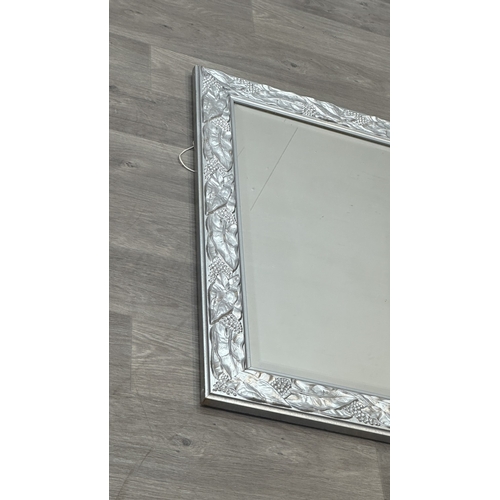 152 - A 19th century style silver painted framed bevelled edge wall mirror with grape and leaf design - ap... 