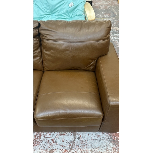 19 - A modern brown leather two seater sofa - approx. 88cm high x 152cm wide x 85cm deep
