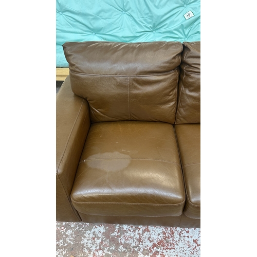 19 - A modern brown leather two seater sofa - approx. 88cm high x 152cm wide x 85cm deep