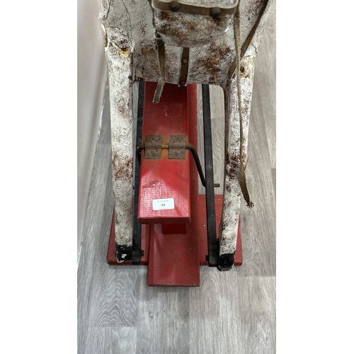 22 - An early 20th century painted plaster and carved wooden rocking horse - approx. 106cm high x 41cm wi... 