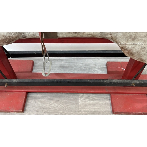 22 - An early 20th century painted plaster and carved wooden rocking horse - approx. 106cm high x 41cm wi... 