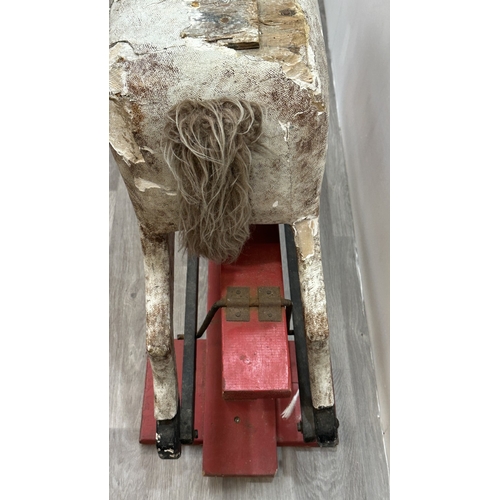 22 - An early 20th century painted plaster and carved wooden rocking horse - approx. 106cm high x 41cm wi... 