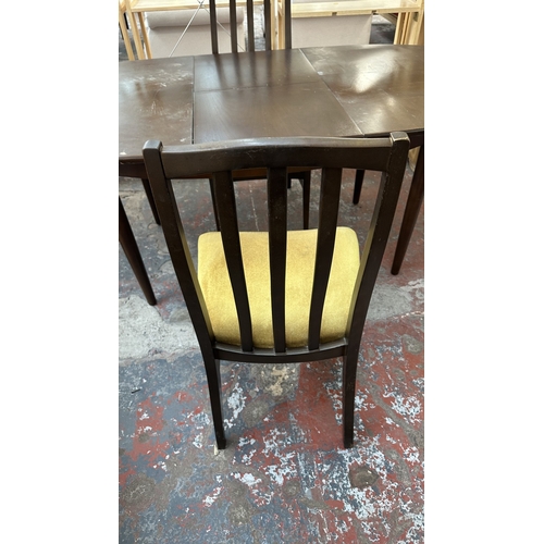 23 - A mid 20th century stained teak extending dining table and four fabric upholstered chairs - approx. ... 