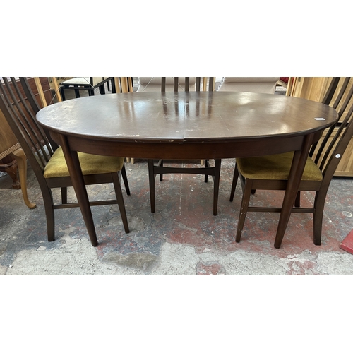 23 - A mid 20th century stained teak extending dining table and four fabric upholstered chairs - approx. ... 