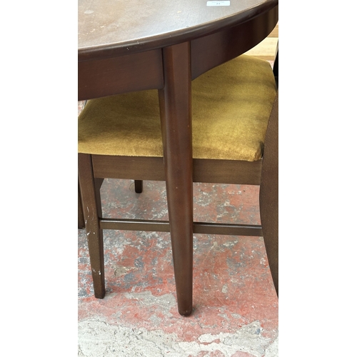 23 - A mid 20th century stained teak extending dining table and four fabric upholstered chairs - approx. ... 