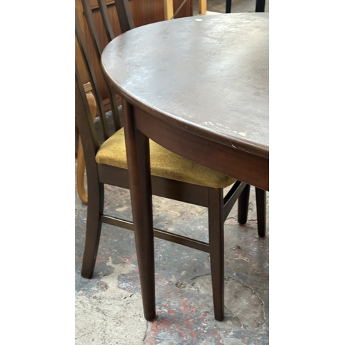23 - A mid 20th century stained teak extending dining table and four fabric upholstered chairs - approx. ... 
