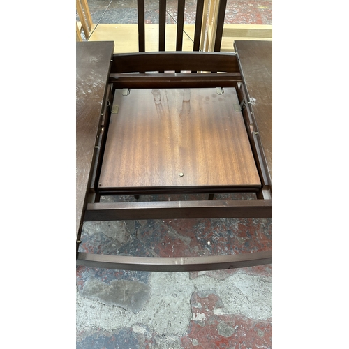 23 - A mid 20th century stained teak extending dining table and four fabric upholstered chairs - approx. ... 