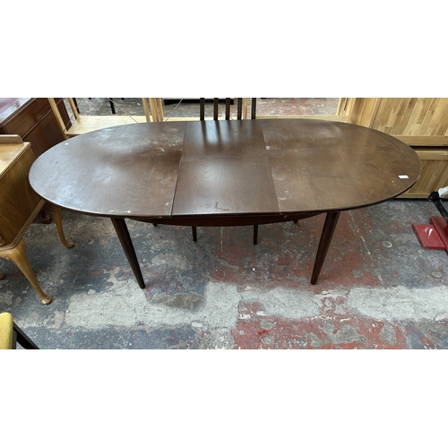 23 - A mid 20th century stained teak extending dining table and four fabric upholstered chairs - approx. ... 