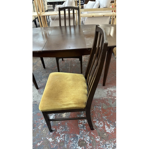 23 - A mid 20th century stained teak extending dining table and four fabric upholstered chairs - approx. ... 