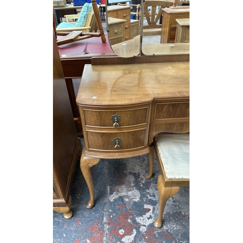 25 - A mid 20th century Heathland Furniture walnut dressing table and stool - approx. 157cm high includin... 