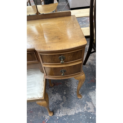 25 - A mid 20th century Heathland Furniture walnut dressing table and stool - approx. 157cm high includin... 