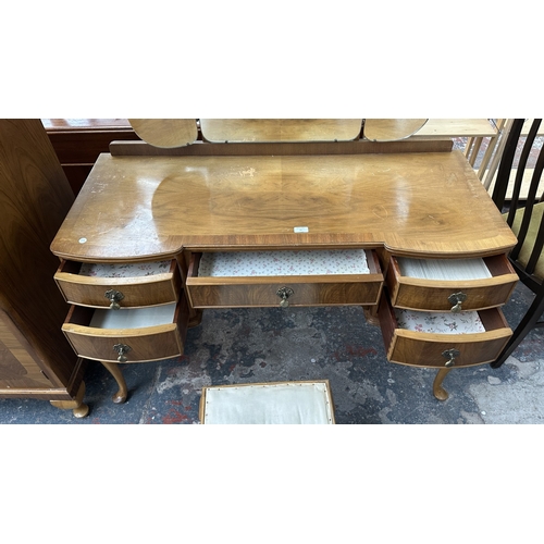 25 - A mid 20th century Heathland Furniture walnut dressing table and stool - approx. 157cm high includin... 