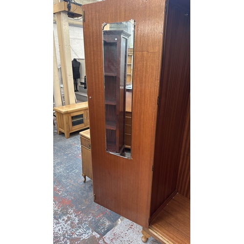 27 - A mid 20th century Heathland Furniture walnut double wardrobe - approx. 198cm high x 125cm wide x 55... 