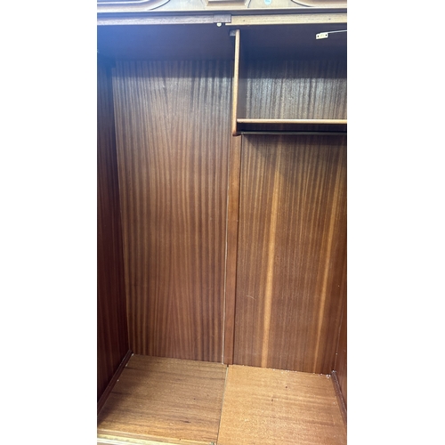 27 - A mid 20th century Heathland Furniture walnut double wardrobe - approx. 198cm high x 125cm wide x 55... 
