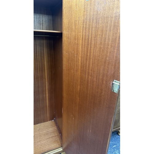 27 - A mid 20th century Heathland Furniture walnut double wardrobe - approx. 198cm high x 125cm wide x 55... 