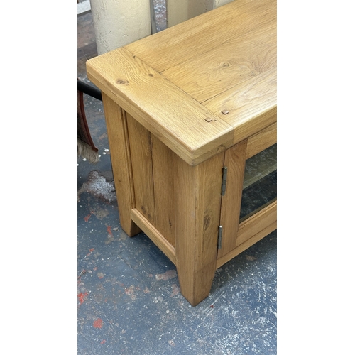 3 - A modern oak TV stand - approx. 56cm high x 130cm wide x 36cm deep