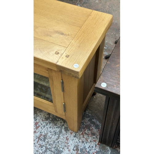 3 - A modern oak TV stand - approx. 56cm high x 130cm wide x 36cm deep
