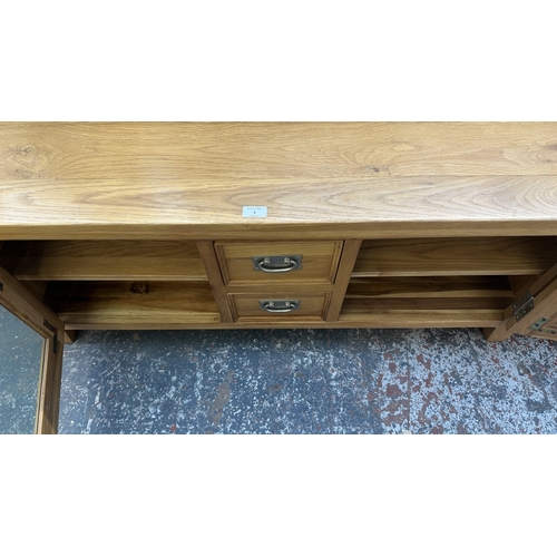 3 - A modern oak TV stand - approx. 56cm high x 130cm wide x 36cm deep