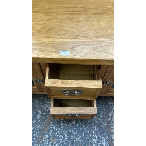 3 - A modern oak TV stand - approx. 56cm high x 130cm wide x 36cm deep