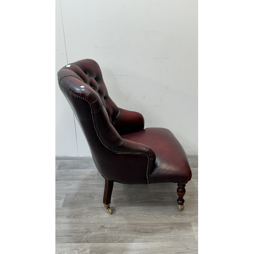37A - A 19th century style oxblood leather Chesterfield armchair on turned beech supports and brass castor... 