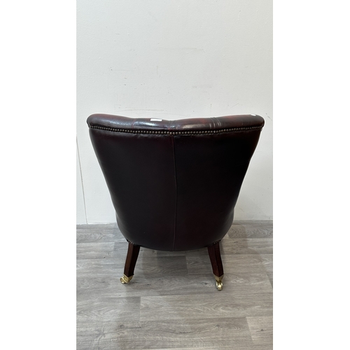 37A - A 19th century style oxblood leather Chesterfield armchair on turned beech supports and brass castor... 